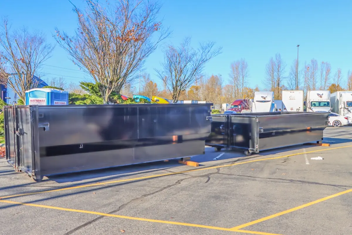 Professional dumpster rental service with roll-off container on residential driveway in Hitchcock